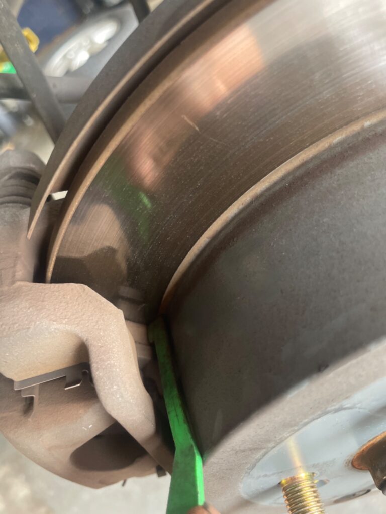 Checking brake pad wear during brake inspection in Houston