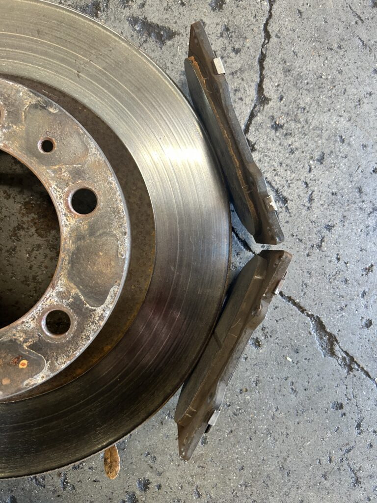 Overheated brake rotor and damaged brake pads caused by seized brake caliper
