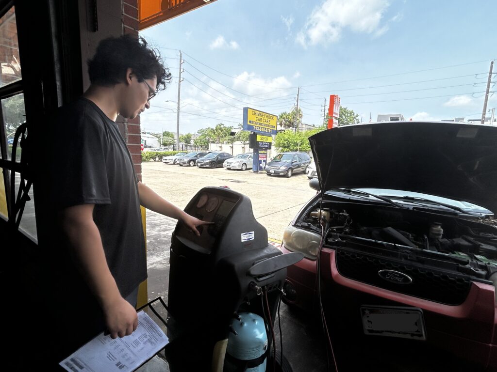 Technician performing A/C blow cold then warm service and refrigerant testing in Houston, TX