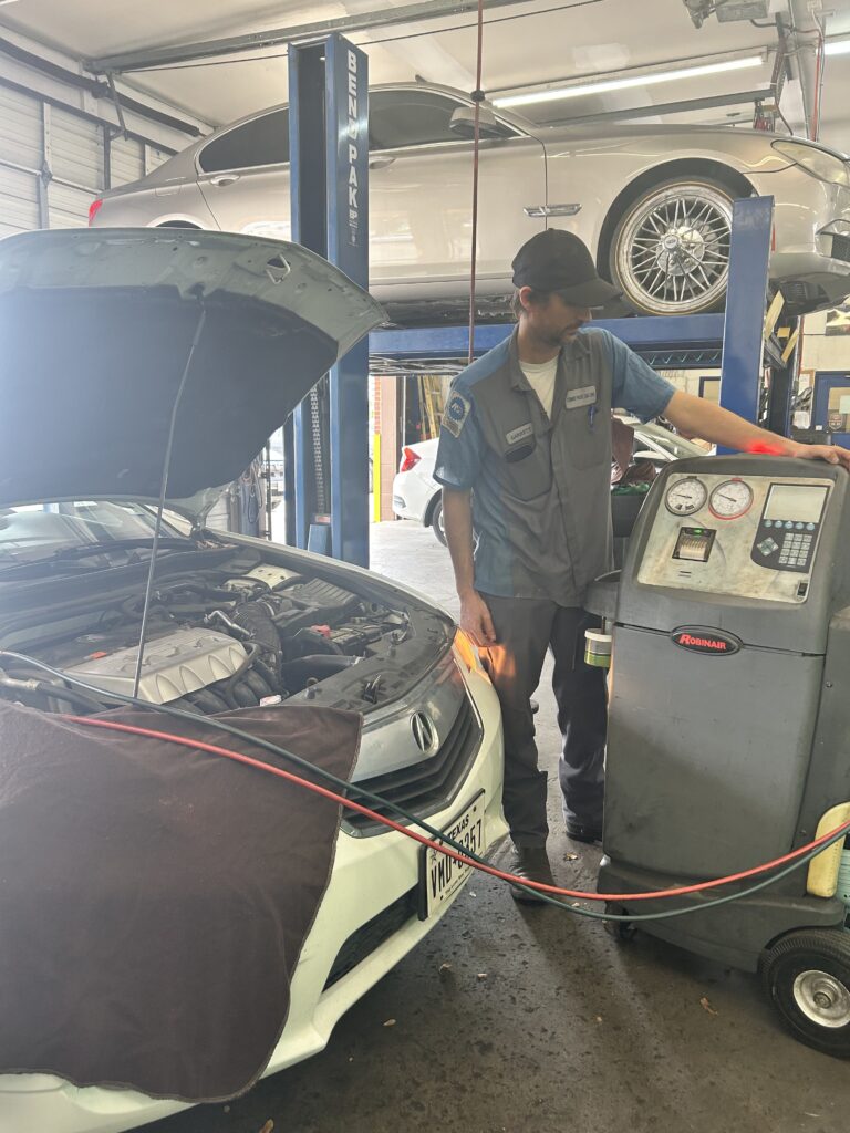 Technician performing air conditioning service in Houston summer