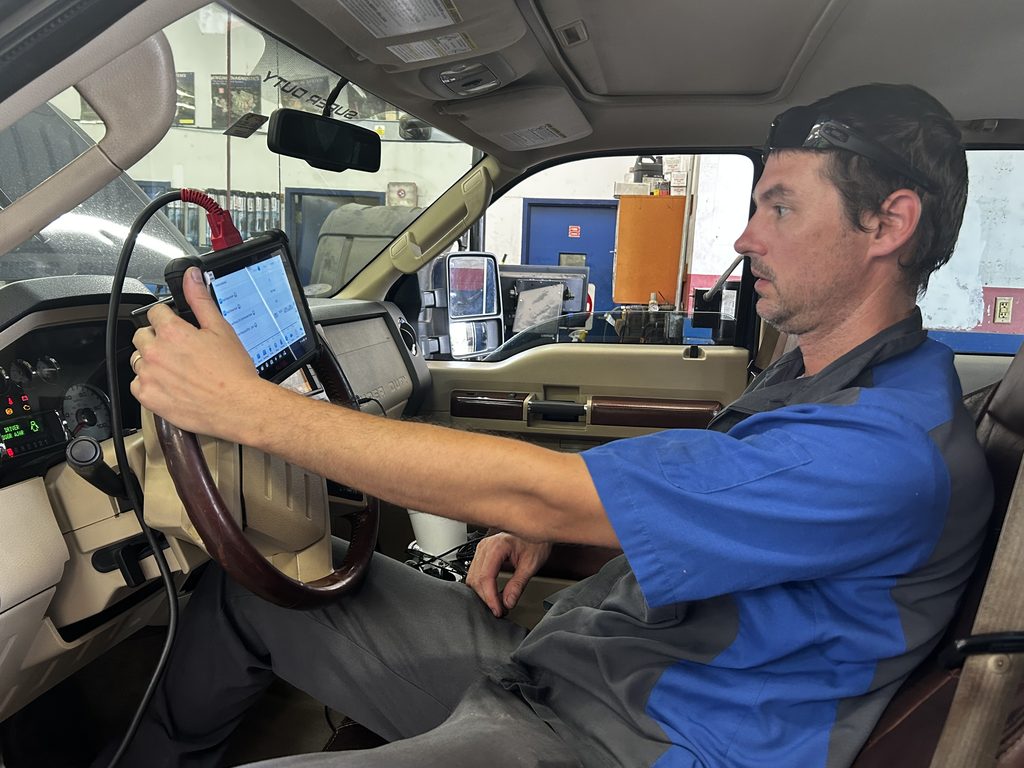 Technician performing check engine light diagnostics at Chimney Rock Car Care in Houston