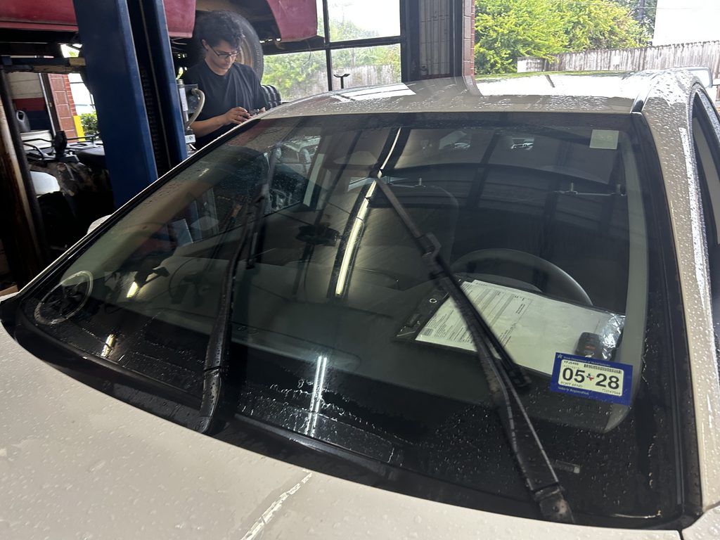 Windshield wipers being checked for rainy Houston weather